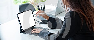 Cropped shot of a business woman sitting at modern office room and using blank screen digital tablet computer with pen