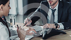 cropped shot of businessman and businesswoman using conference