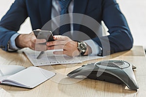 cropped shot of businessman using smartphone