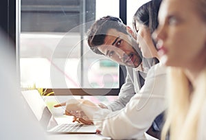 Cropped shot of businesspeople using graph chart and computer laptop, tablet discussing about business plan together in modern