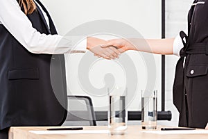 cropped shot of businesswomen shaking hands