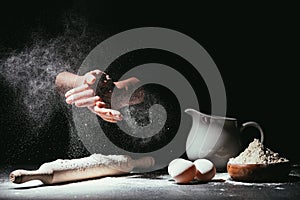 Cropped shot of chef clapping ahnds with flour before making dough