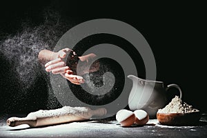 cropped shot of chef clapping ahnds with flour before making dough