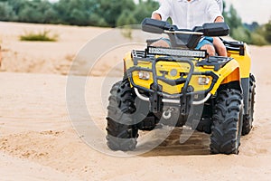 cropped shot of couple riding all-terrain vehicle photo