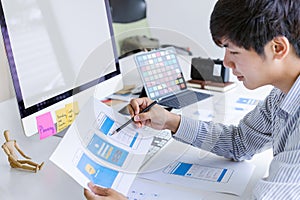 Cropped shot of creative UX UI designer developing programming and coding mobile application from prototype and wireframe layout.