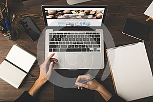 cropped shot of designer using graphics tablet and laptop with depositphotos website