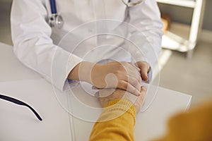 Cropped shot of doctor holding senior patient& x27;s hand reassuring and comforting him