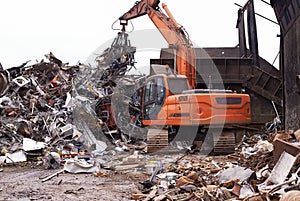 The scrapyard. Cropped shot of an excavator sorting through a pile of scrap metal.
