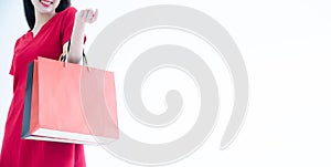 Cropped shot of female hand holding bunch of different colorful blank shopping bags over isolated white background. Many packets