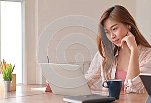 Cropped shot of Female teenage student are studying online at home with a laptop