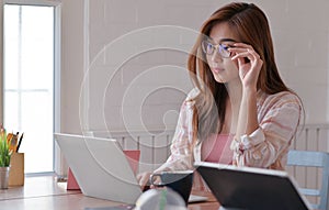 Cropped shot of Female teenage student are studying online at home with a laptop
