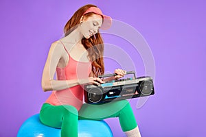 Cropped shot of fit and beautiful woman with portable cassette player