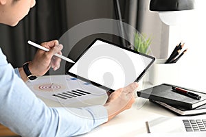 Cropped shot of graphic designer using stylus pen drawing on tablet at his workspace.