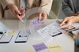 A cropped shot of a group of UX and UI graphic designers working in the meeting