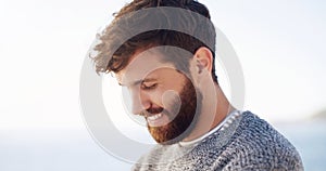 The beard is what makes the man. Cropped shot of a handsome young man spending the day at the beach.