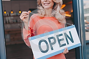 cropped shot of happy small business owner holding sign