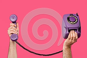cropped shot of man holding purple rotary phone isolated