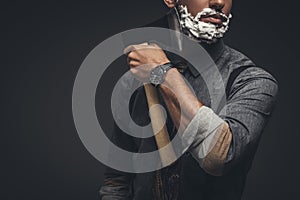 Cropped shot of man with shaving cream on his face, grooming his beard