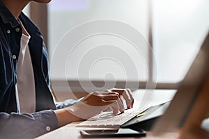 Cropped shot man using computer with typing computer keyboard