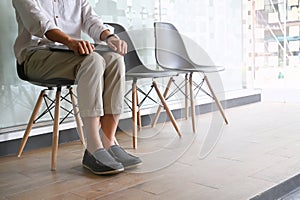 Cropped shot Man waiting interview sitting on chair