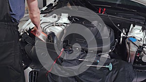 Cropped shot of mechanic reparing broken car