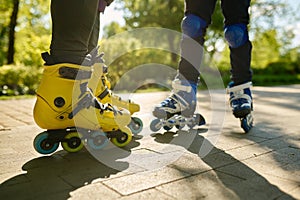 Cropped shot of man and boy legs wearing rollerblades