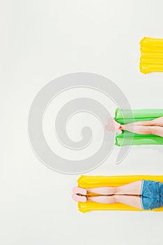 cropped shot of people resting on inflatable mattresses