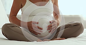 Cropped shot of pregnant woman wearing white tank top