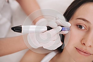 Young woman getting facial skincare treatment photo