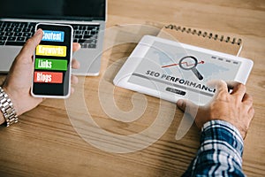 cropped shot of professional developer using different gadgets
