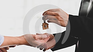 Cropped shot of Real estate agent giving a property's key to customer.