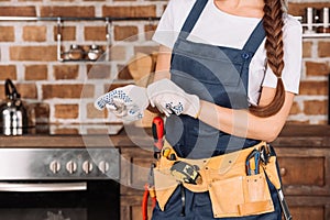 cropped shot of repairwoman putting