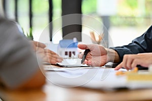 Cropped shot of senior woman talking and discussing financial plan or investment plan with financial adviser