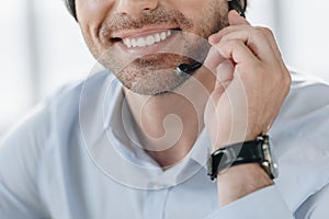 cropped shot of smiling support hotline worker