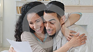 Cropped shot Spanish couple Hispanic bearded handsome young man and curly Spaniard woman receive letter open envelope