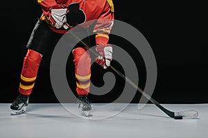 cropped shot of sportsman with hockey stick playing ice hockey