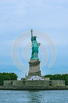 Cropped shot of Statue of Liberty with water and sky.