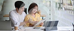 Cropped shot of two businesspeople sitting in glass glass wall office room