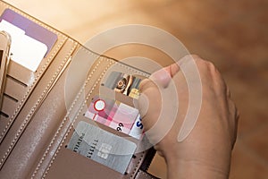 Cropped shot view of female hands picking credit cards from her wallet