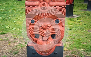 The cropped shot view of the traditional Maori wood carving statue.