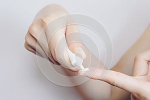 Cropped shot view of woman hands preparing for applying cosmetic cream.