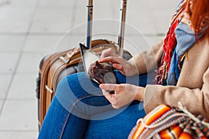 Cropped shot view of woman tourist holding gadget tablet with navigation application and planned route on the screen, female looki