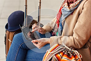 Cropped shot view of woman tourist holding gadget tablet with navigation application and planned route on the screen, female looki