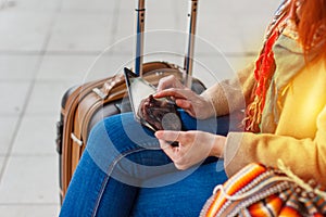 Cropped shot view of woman tourist holding gadget tablet with navigation application and planned route on the screen, female looki