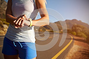 Cropped shot of woman checking her sports watch