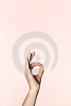 cropped shot of woman doing ok gesture by hand