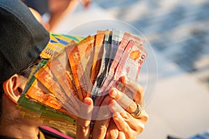 Cropped shot of woman hand holding a group of Sri Lanka banknotes in her hand.