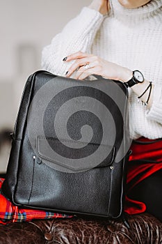 Cropped shot of woman holding black bag