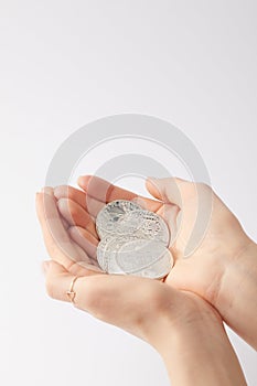 cropped shot of woman holding pile of bitcoins in hands isolated on white