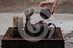Cropped shot of woman pouring tea in traditional chinese teaware
